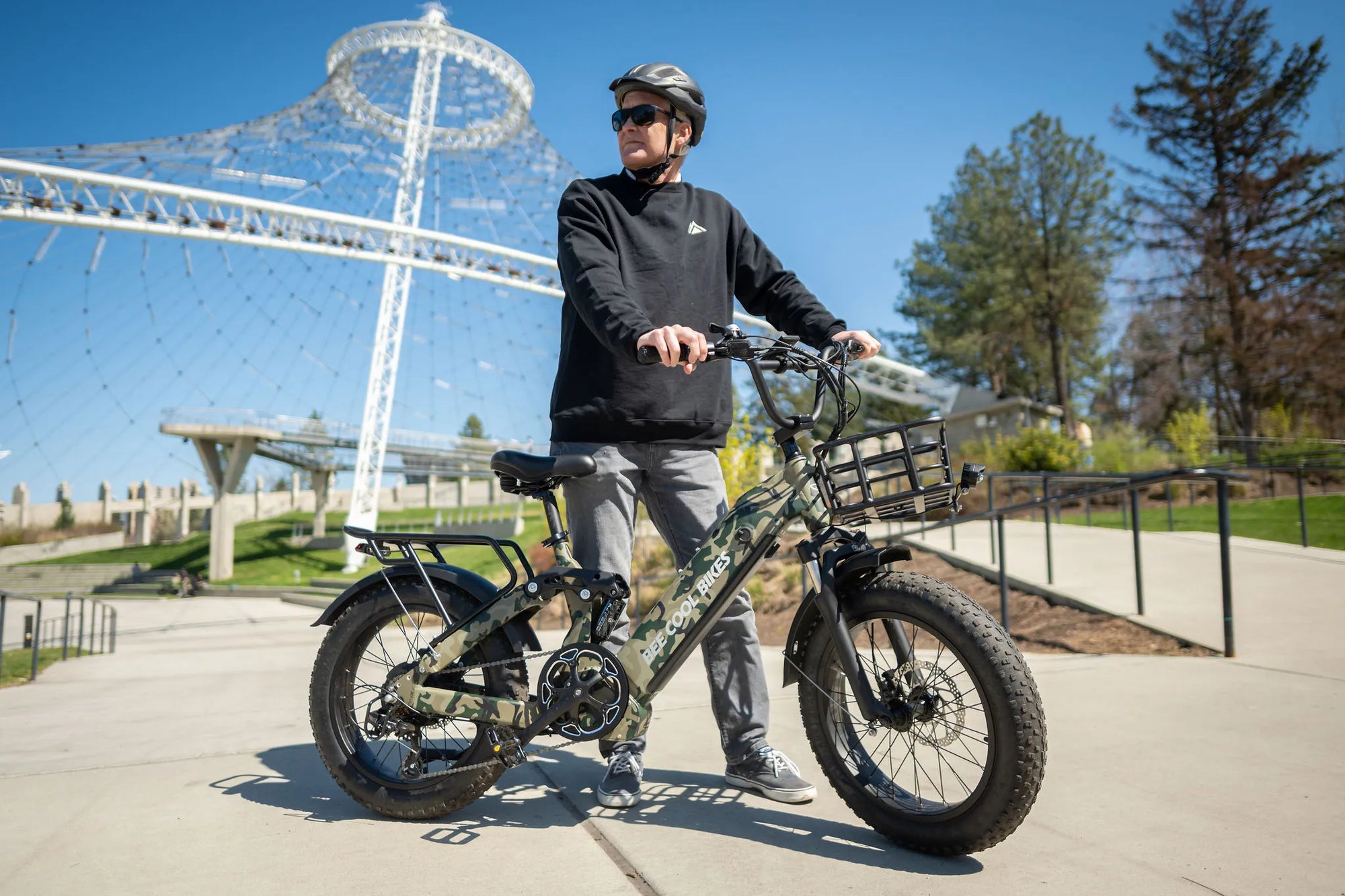 Bee Ranger eBike in forest camo color with full suspension system, showcased on an off-road trail